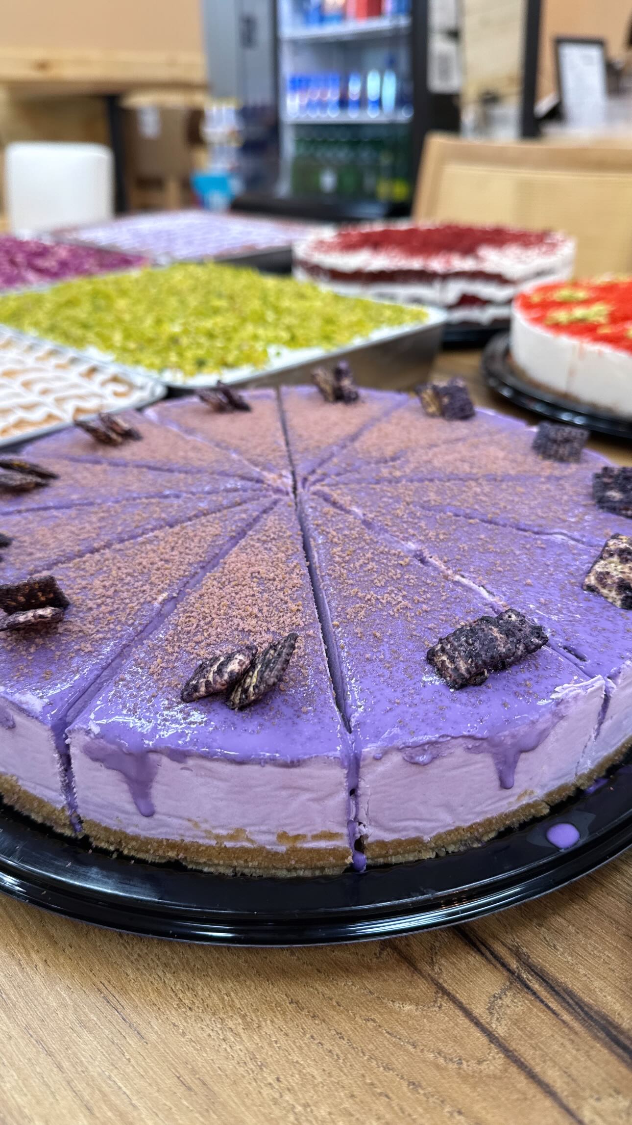 Sliced purple cheesecake with cookie crumble at Finjan Coffee House