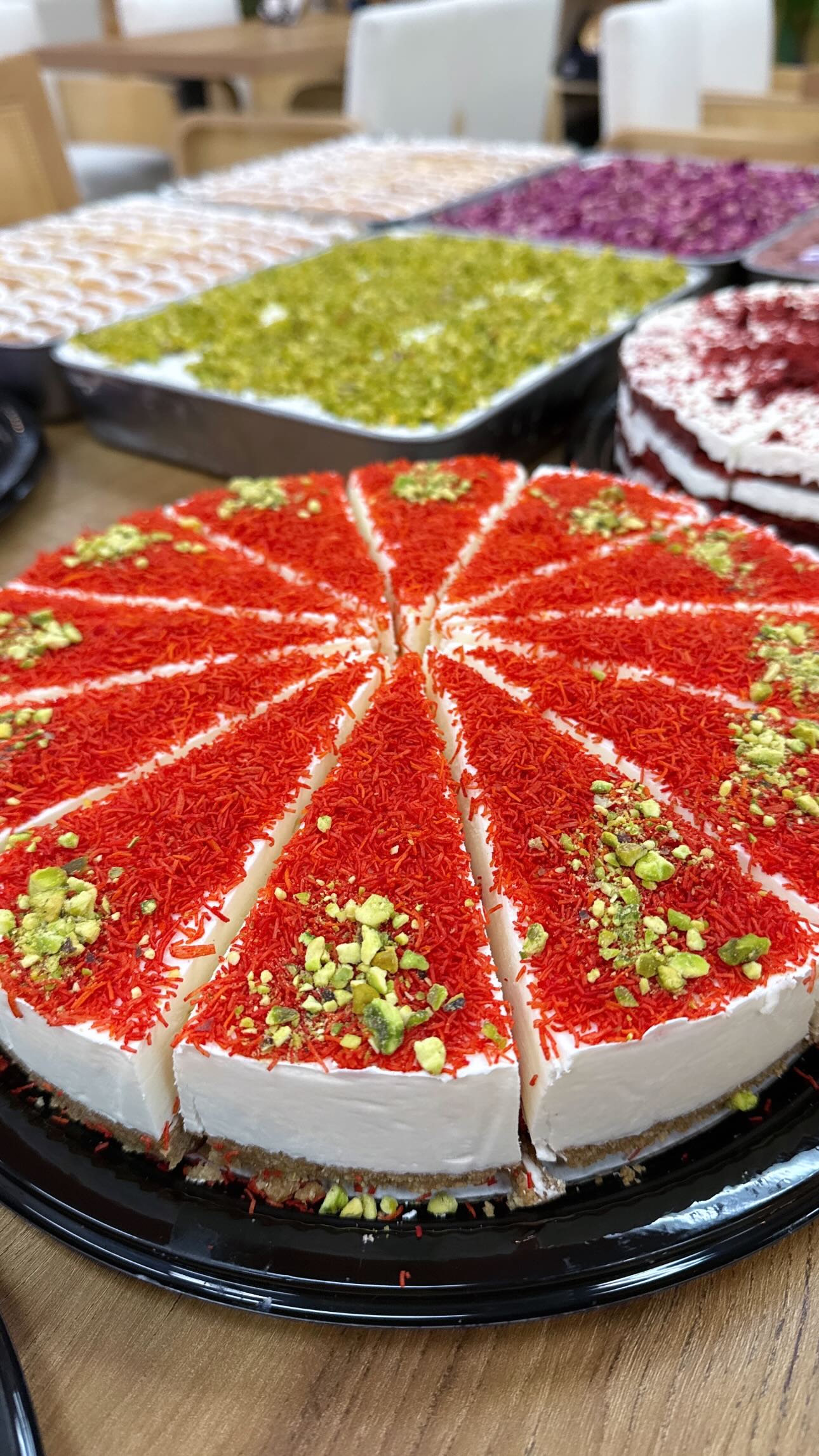 Sliced red cheesecake with pistachio at Finjan Coffee House