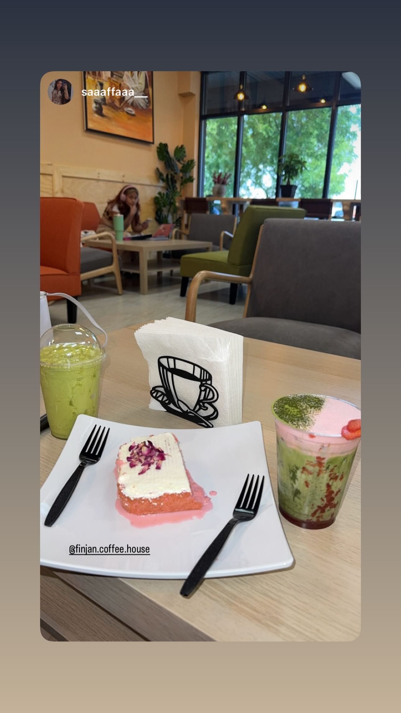 A guest enjoying drinks and cake inside Finjan Coffee House