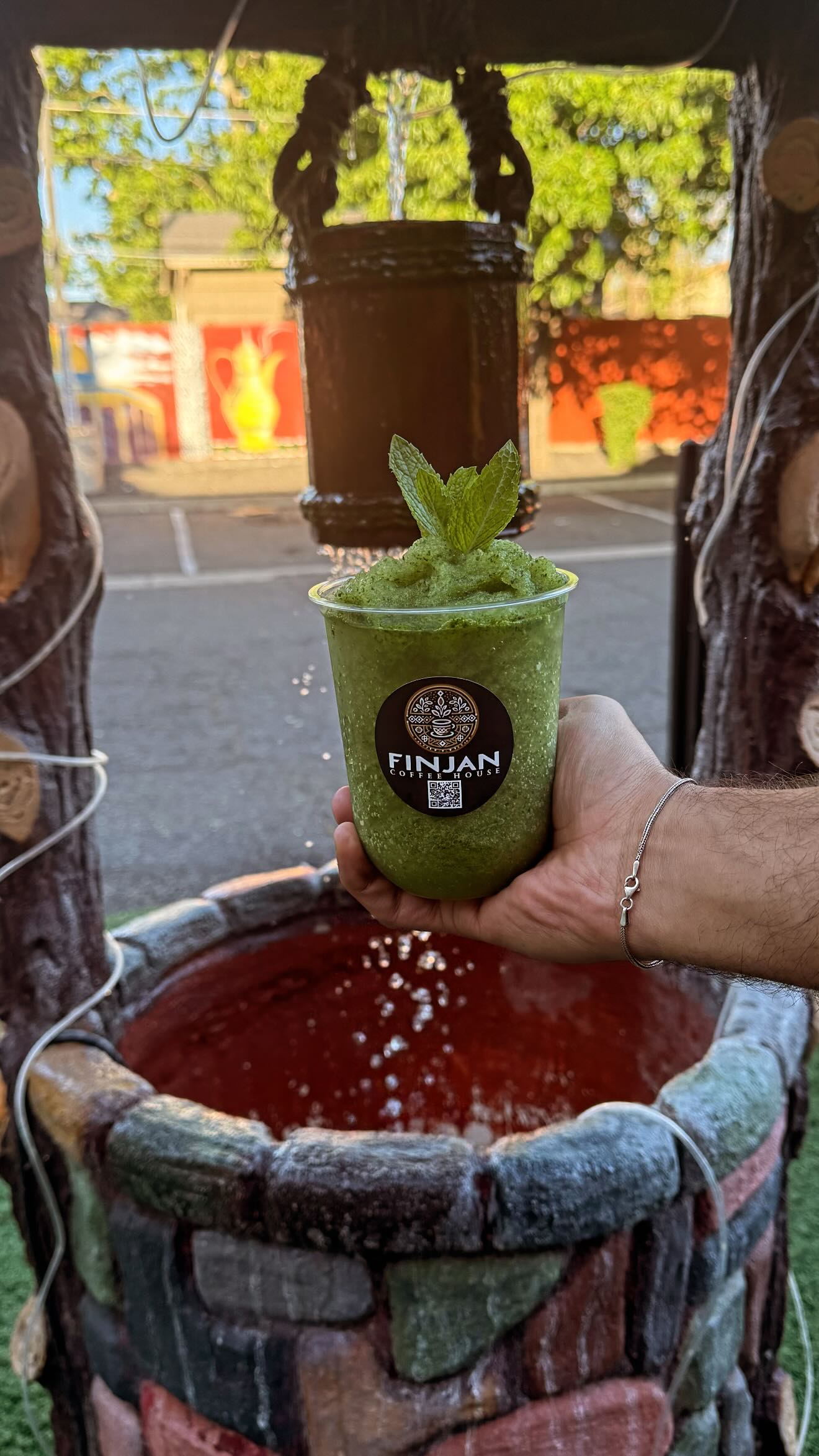 Iced mint drink at Finjan's outdoor wishing well