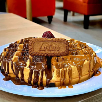 Close-up of a Lotus Biscoff waffle drizzled with chocolate and caramel